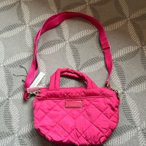 Marc Jacob’s NY pocketbook. Can be used crossbody or handles for a tote